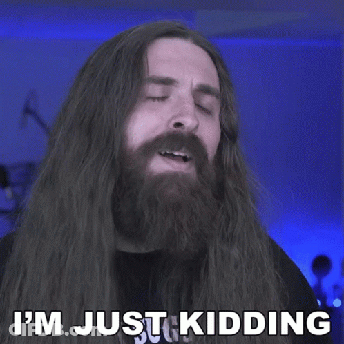 A Man With Long Hair And A Beard Has The Words I 'M Just Kidding Behind Him GIF
