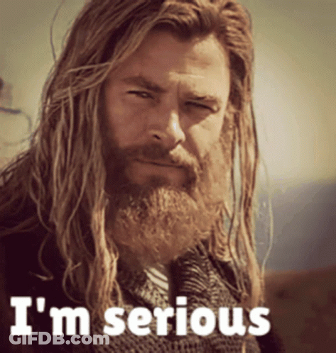 A Man With Long Hair And A Beard Has The Words I 'M Serious On His Face GIF