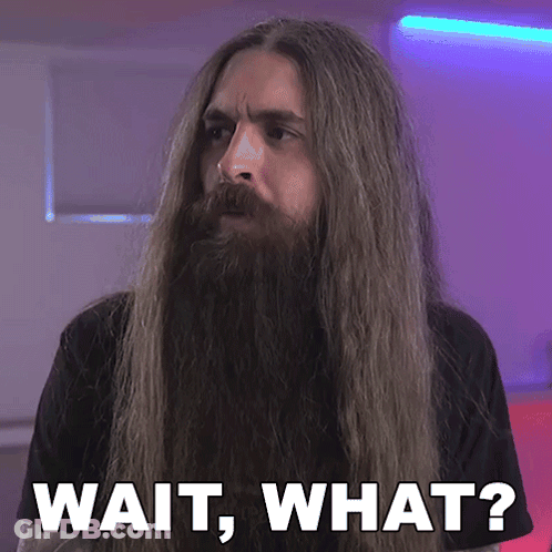 A Man With Long Hair And A Beard Has The Words Wait What Written Below Him GIF