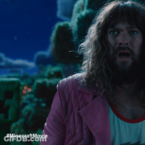 A Man With Long Hair And A Beard In A Pink Jacket GIF