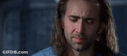 A Man With Long Hair And A Beard Is Crying In A Room . GIF