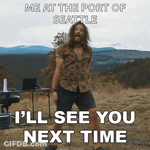 A Man With Long Hair And A Beard Is Dancing In A Field With Mountains In The Background GIF