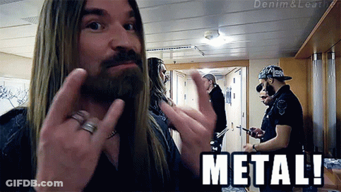 A Man With Long Hair And A Beard Is Giving The Middle Finger And The Word Metal Is Below Him GIF