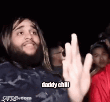 A Man With Long Hair And A Beard Is Giving The Middle Finger In A Crowd Of People . GIF