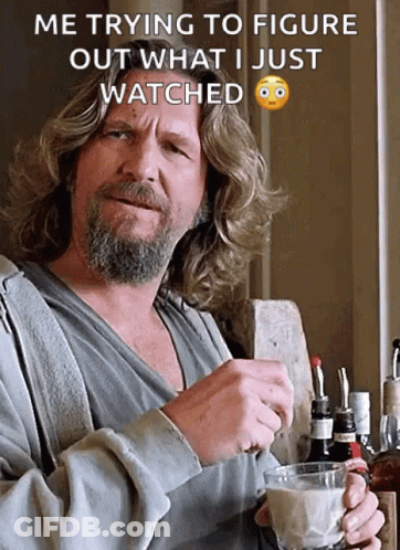 A Man With Long Hair And A Beard Is Holding A Cup Of Coffee And A Bottle Of Whiskey In His Hand GIF