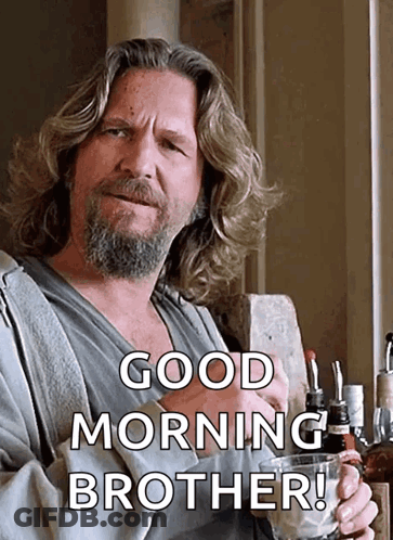 A Man With Long Hair And A Beard Is Holding A Glass Of Whiskey And Saying Good Morning Brother GIF