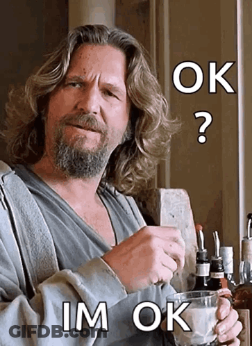 A Man With Long Hair And A Beard Is Holding A Glass With The Words Ok Im Ok Above Him GIF