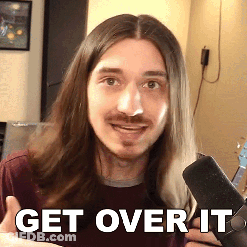 A Man With Long Hair And A Beard Is Holding A Microphone And Says Get Over It GIF