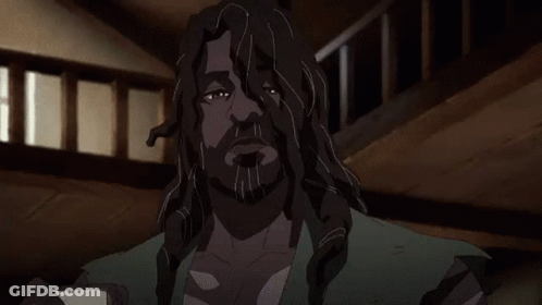 A Man With Long Hair And A Beard Is Holding A Piece Of Paper In His Hands . GIF