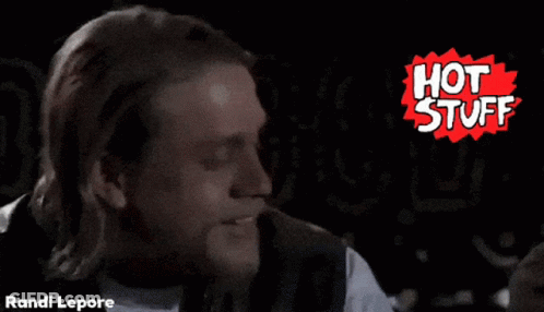 A Man With Long Hair And A Beard Is In Front Of A Hot Stuff Logo GIF