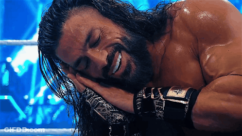A Man With Long Hair And A Beard Is Laying Down With His Eyes Closed GIF