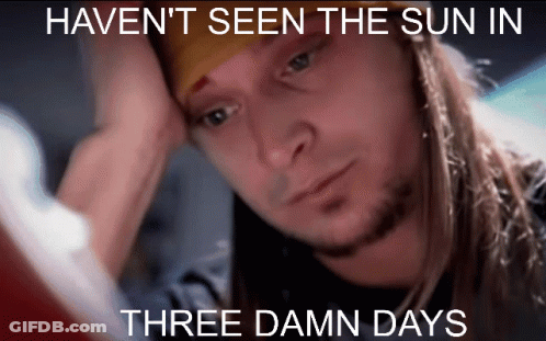 A Man With Long Hair And A Beard Is Looking At A Computer Screen With The Caption Haven 'T Seen The Sun In Three Damn Da GIF