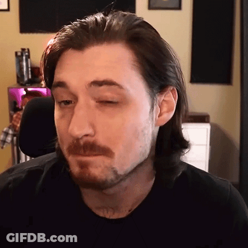 Man With Long Hair And Beard Looking At Camera GIF