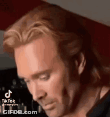 Man With Long Hair And Beard Looking Down GIF
