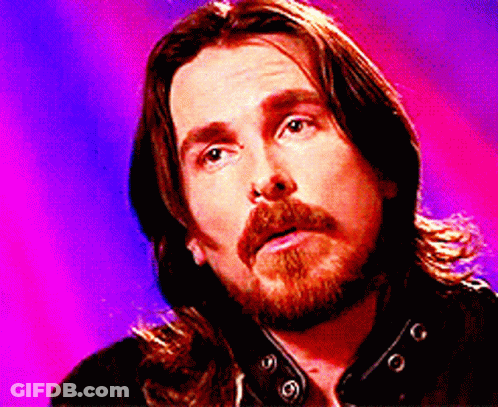 A Man With Long Hair And A Beard Is Looking Up GIF