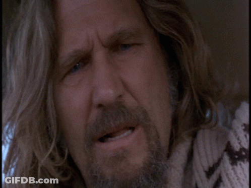 A Man With Long Hair And A Beard Is Making A Face GIF