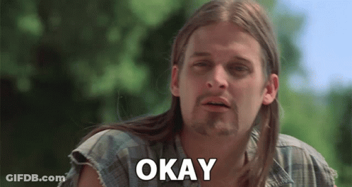 A Man With Long Hair And A Beard Is Making A Funny Face And Saying Okay . GIF