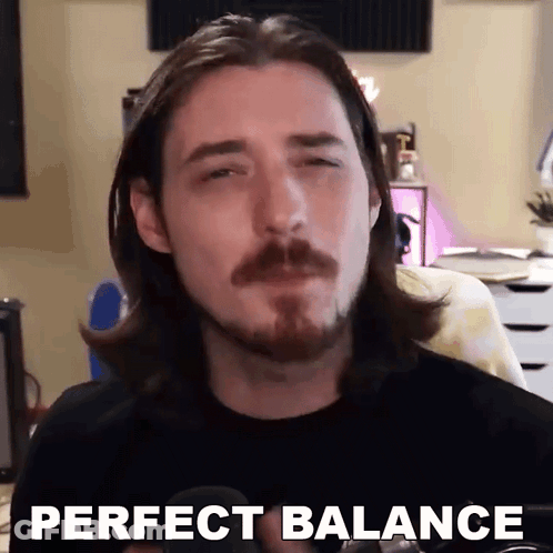 A Man With Long Hair And A Beard Is Making A Funny Face And Saying `` Perfect Balance '' . GIF