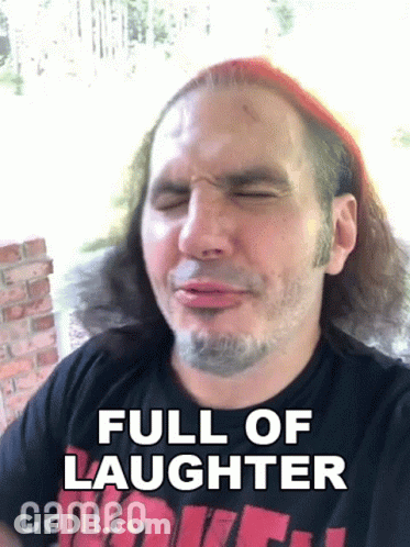 A Man With Long Hair And A Beard Is Making A Funny Face And Says Full Of Laughter Cameo On The Bottom . GIF
