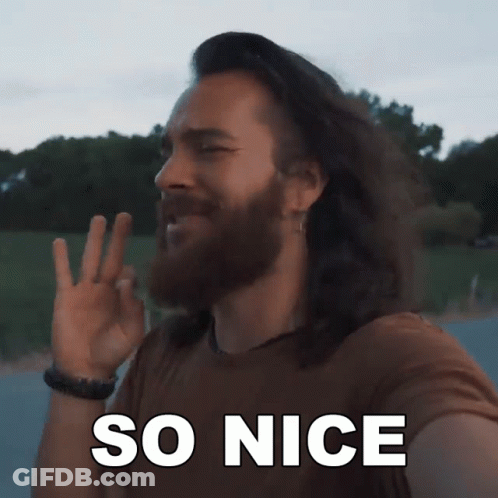 A Man With Long Hair And A Beard Is Making A Peace Sign With The Words So Nice Behind Him GIF