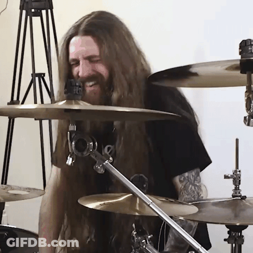 Man With Long Hair And Beard Playing Drums GIF