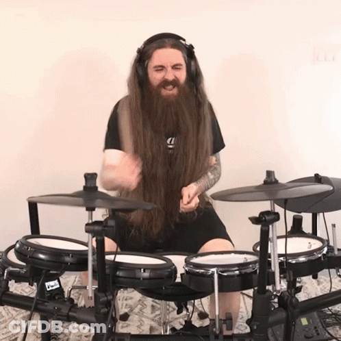 Man With Long Hair And Beard Playing Drum Set GIF