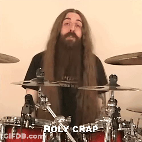 Man With Long Hair And Beard Playing Drums Saying Holy Crap GIF