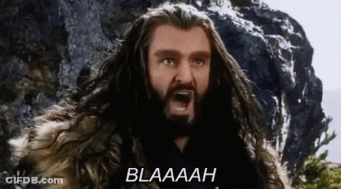 A Man With Long Hair And A Beard Is Screaming With The Word Blaaah Written Below Him . GIF