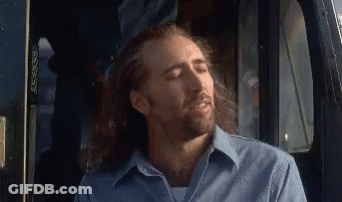 A Man With Long Hair And A Beard Is Sitting In A Truck With His Eyes Closed GIF
