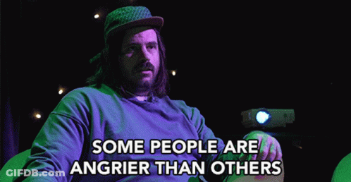 A Man With Long Hair And A Beard Is Sitting In Front Of A Projector And Says " Some People Are Angrier Than Others " GIF