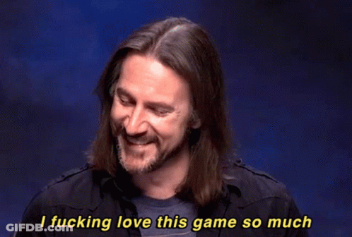 A Man With Long Hair And A Beard Is Smiling And Saying " I Fucking Love This Game So Much " GIF