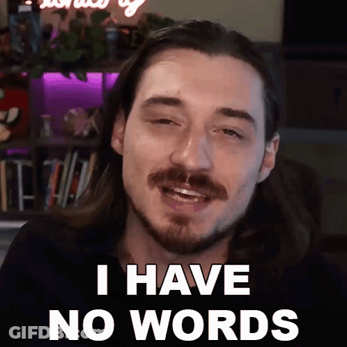A Man With Long Hair And A Beard Is Smiling And Saying I Have No Words GIF