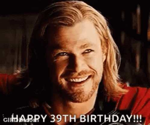 A Man With Long Hair And A Beard Is Smiling And Says Happy 39Th Birthday . GIF