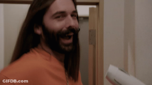A Man With Long Hair And A Beard Is Smiling GIF
