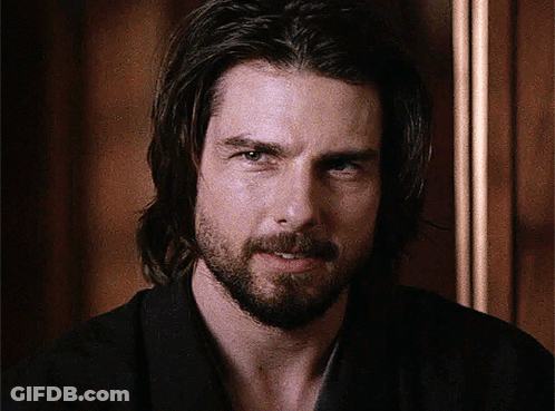 A Man With Long Hair And A Beard Is Smiling For The Camera GIF