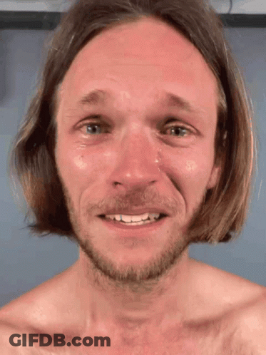 A Man With Long Hair And A Beard Is Smiling With Tears Coming Out Of His Eyes GIF