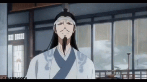 A Man With Long Hair And A Beard Is Standing In A Room With A Lot Of Windows GIF