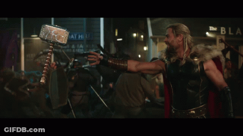 A Man With Long Hair And A Beard Is Standing In Front Of A Crowd GIF