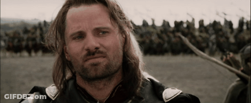 A Man With Long Hair And A Beard Is Standing In Front Of A Crowd Of Soldiers GIF