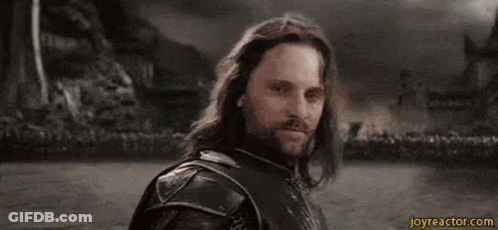 A Man With Long Hair And A Beard Is Standing In Front Of A Crowd With The Word Yolo Written On His Face . GIF
