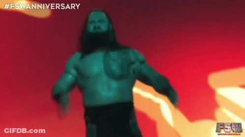 A Man With Long Hair And A Beard Is Standing In Front Of A Red And Yellow Background . GIF