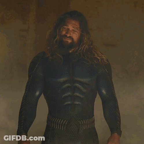 A Man With Long Hair And A Beard Is Standing In Front Of A Sign That Says " You Look Rough " GIF