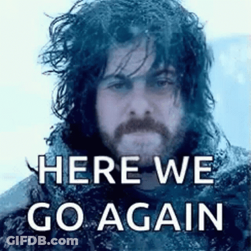 A Man With Long Hair And A Beard Is Standing In The Snow With The Words `` Here We Go Again '' Written Above Him . GIF