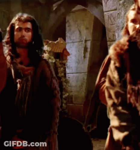 Man With Long Hair And Beard Next To Another Man In Castle GIF