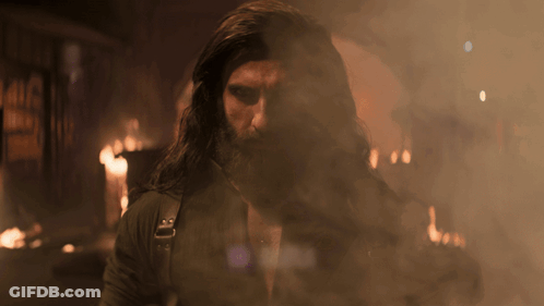 A Man With Long Hair And A Beard Is Surrounded By Smoke And Aura GIF
