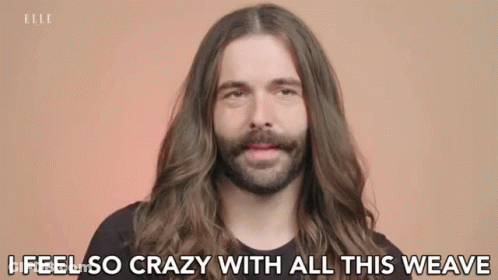 A Man With Long Hair And A Beard Is Talking About His Hair . GIF