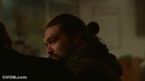 A Man With Long Hair And A Beard Is Talking To Another Man . GIF