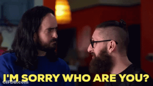 Man With Long Hair And Beard Talking To Man With Glasses GIF