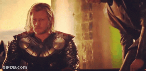 A Man With Long Hair And A Beard Is Wearing A Armored Suit GIF