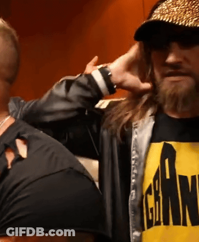 A Man With Long Hair And A Beard Is Wearing A Black And Yellow Shirt That Says Gear On It GIF
